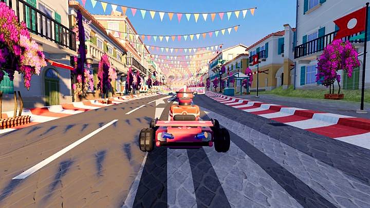 A kart racing through an old town street with bunting overhead